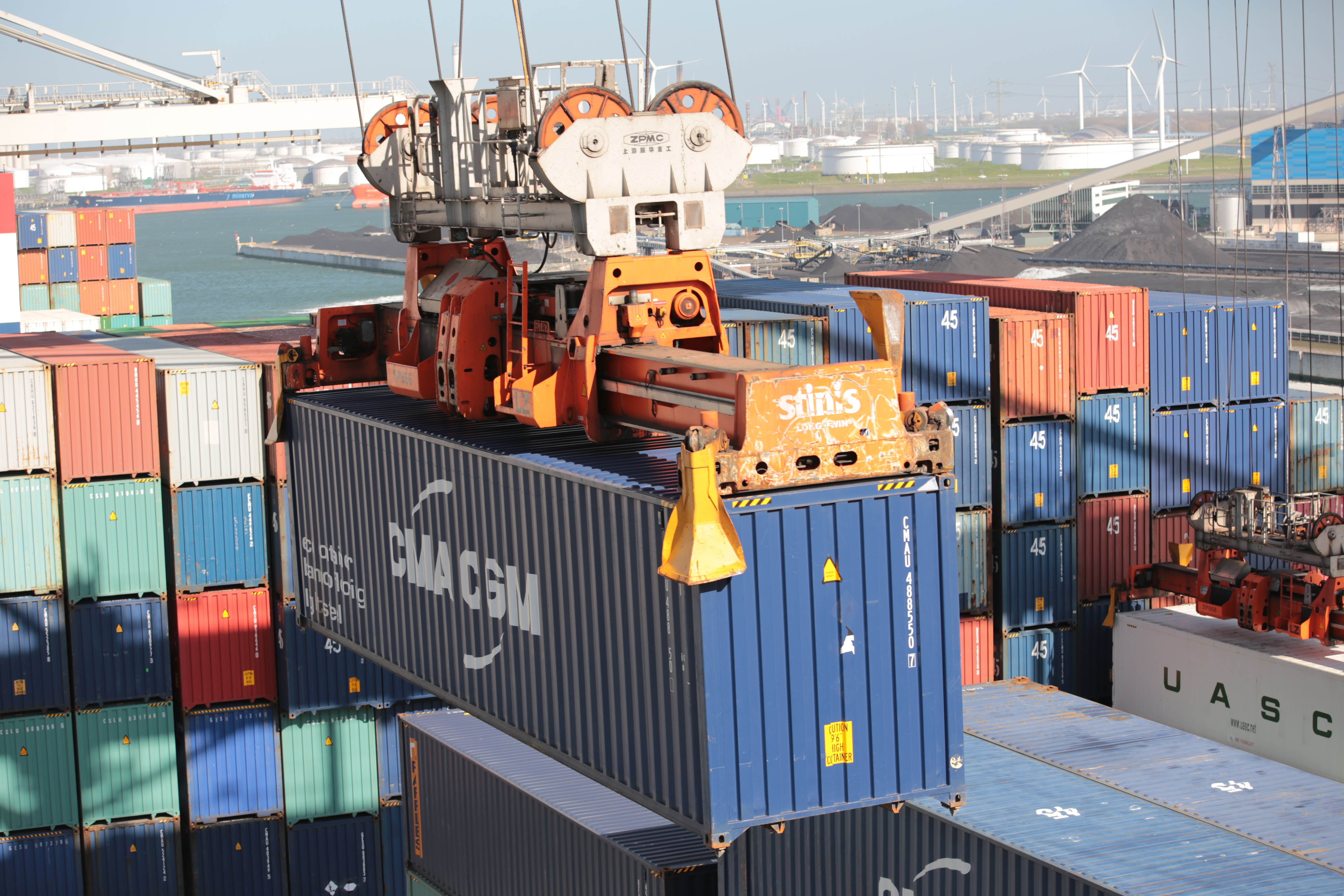 A blue container being moved by an out of frame crane